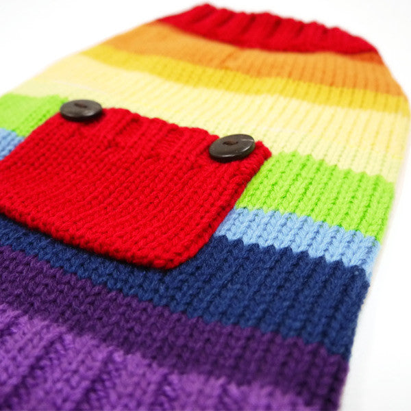 Close-up of rainbow knit dog sweater: red pocket flap with gray buttons and stripes