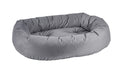 Round gray fabric donut-shaped dog bed with raised bolster and cushioned interior