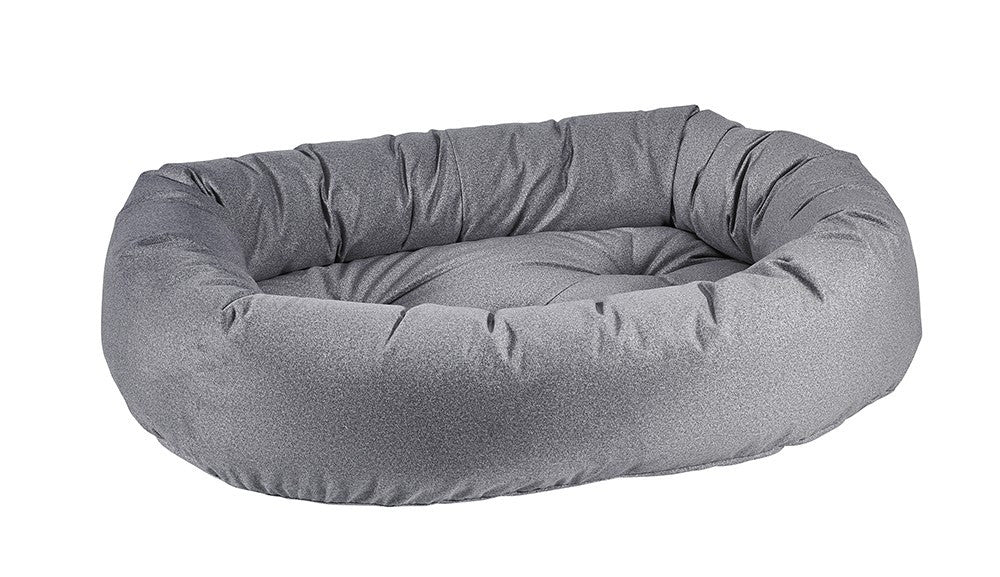 Round gray fabric donut-shaped dog bed with raised bolster and cushioned interior