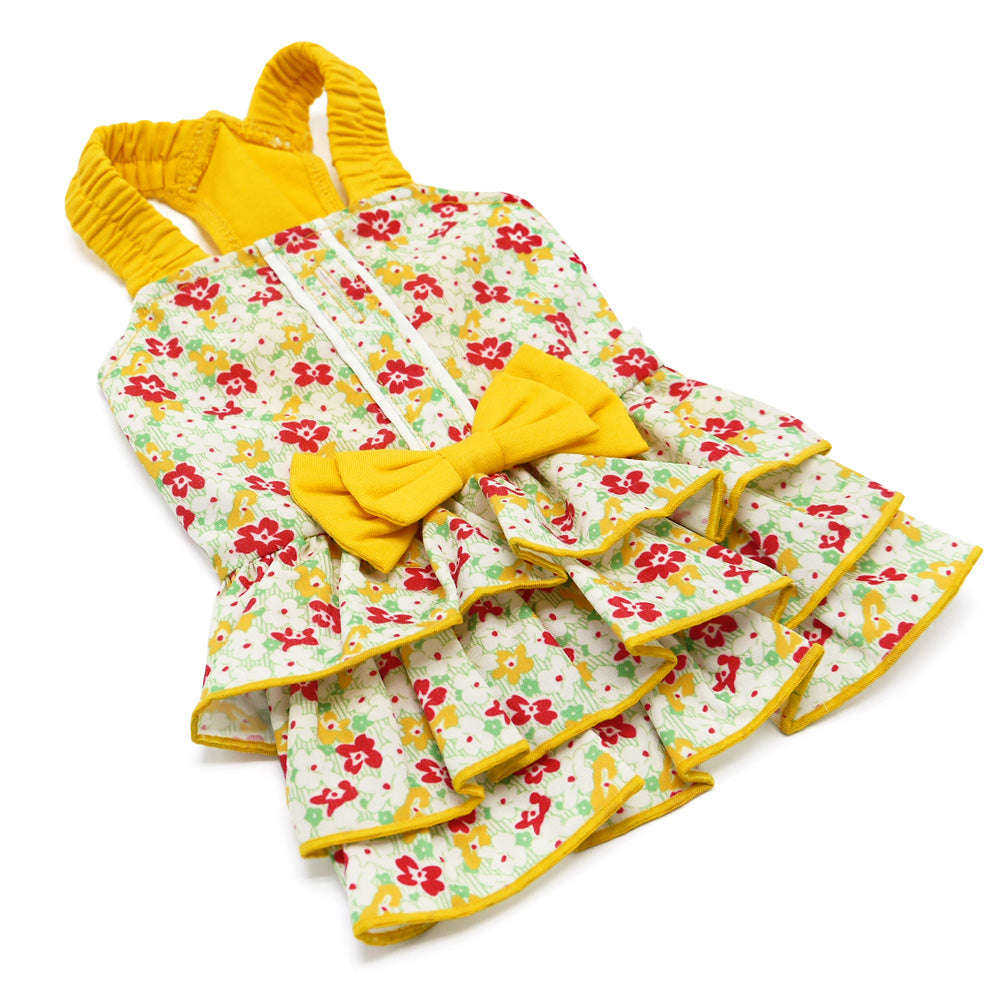 Floral dog dress with yellow trim, layered ruffle skirt, and bow detail