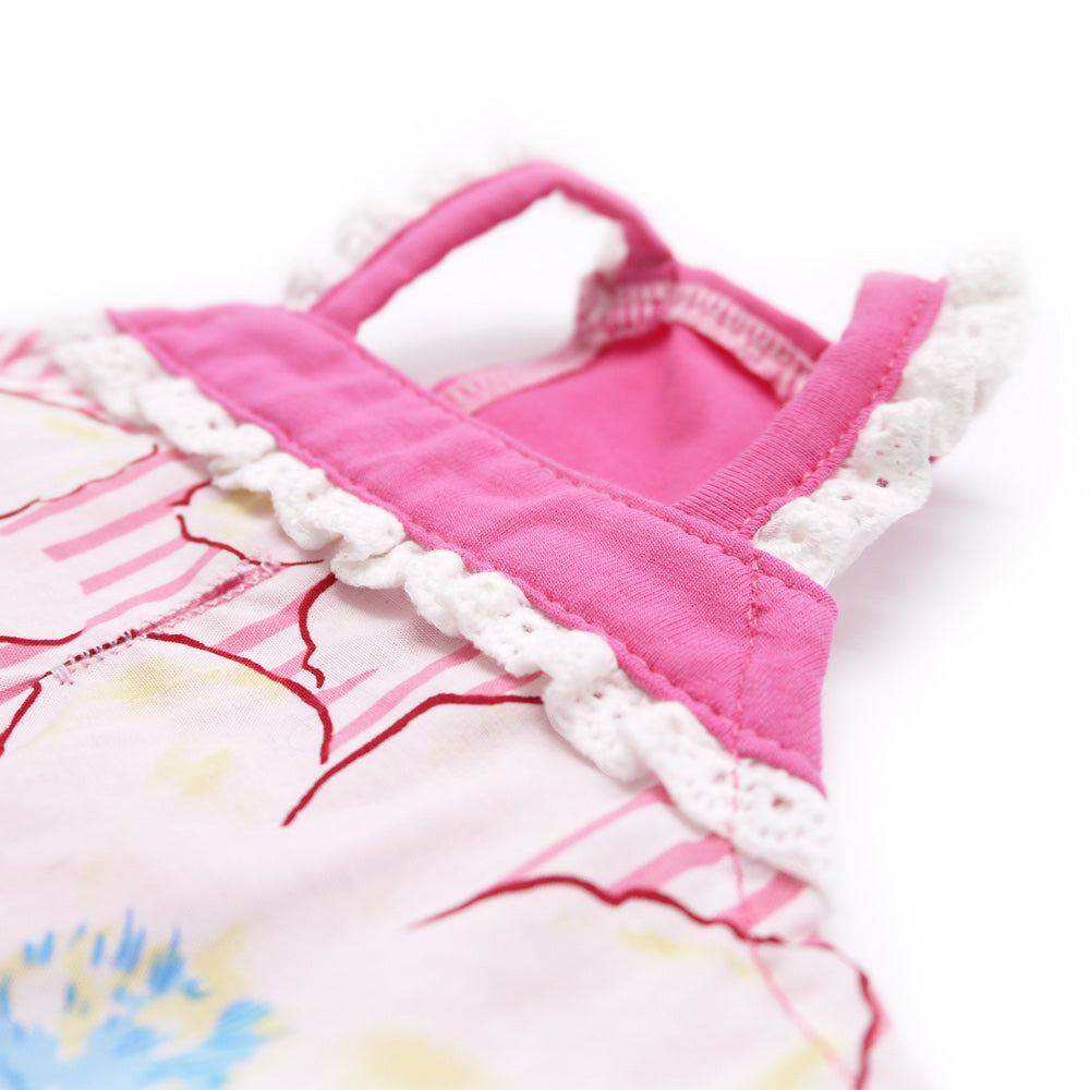 Pink-and-white dog dress with frilly trim, floral print, and a fabric strap