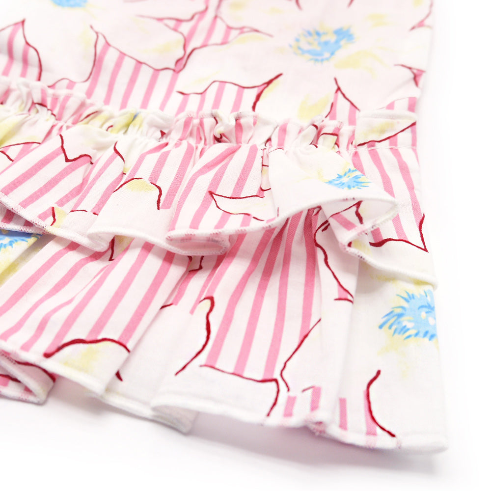 Detail of ruffled dog dress fabric: white with pink stripes and blue flower accents