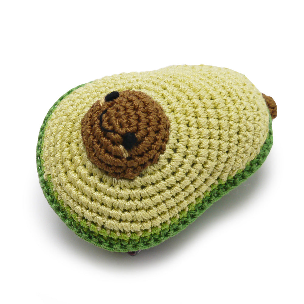 Crochet avocado dog toy with squeaker, pale green body and brown stitched face patch