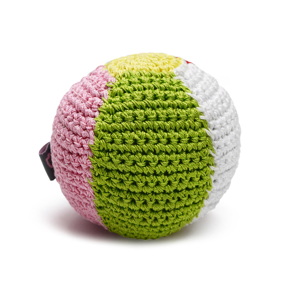Crocheted dog ball toy with squeaker, bright green face with white, pink, and red sides