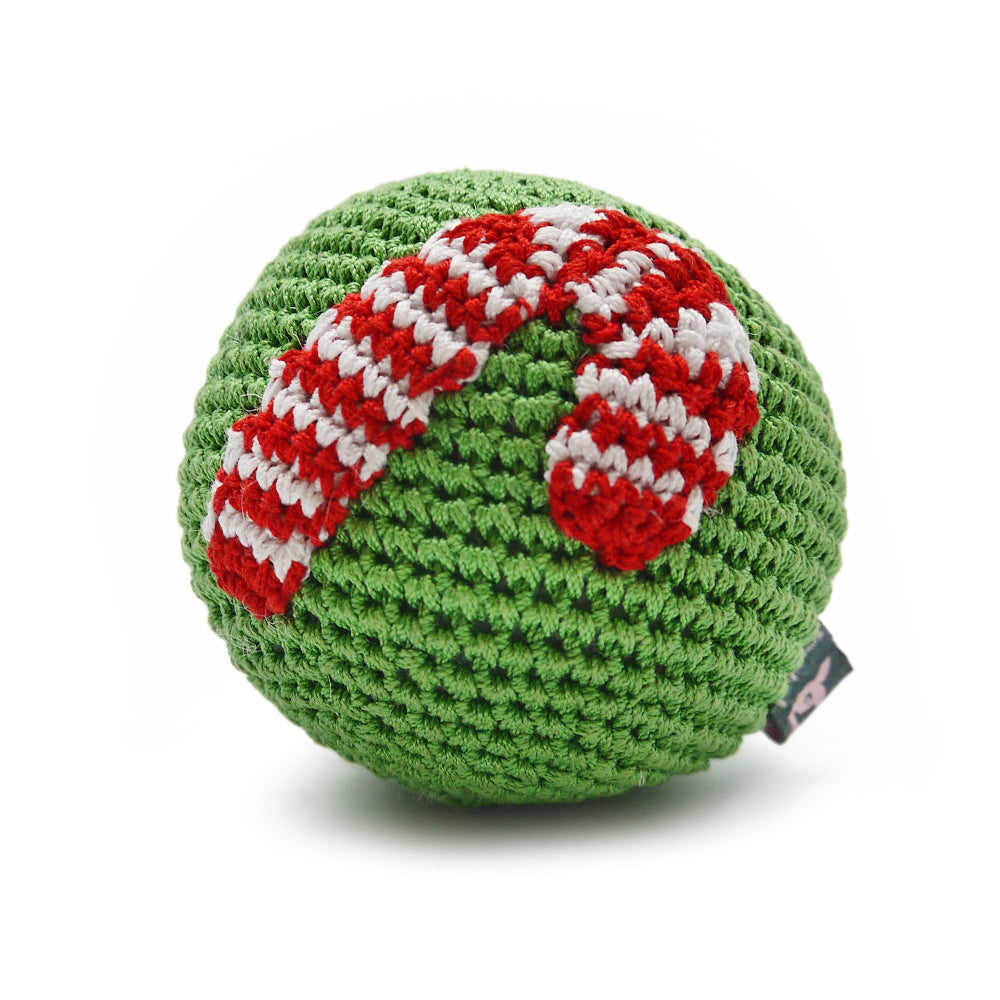 Green crochet dog toy ball with red and white candy-cane striped detail and tag