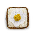 Crochet egg-shaped dog toy with squeaker, square pouch, white and yellow yolk design
