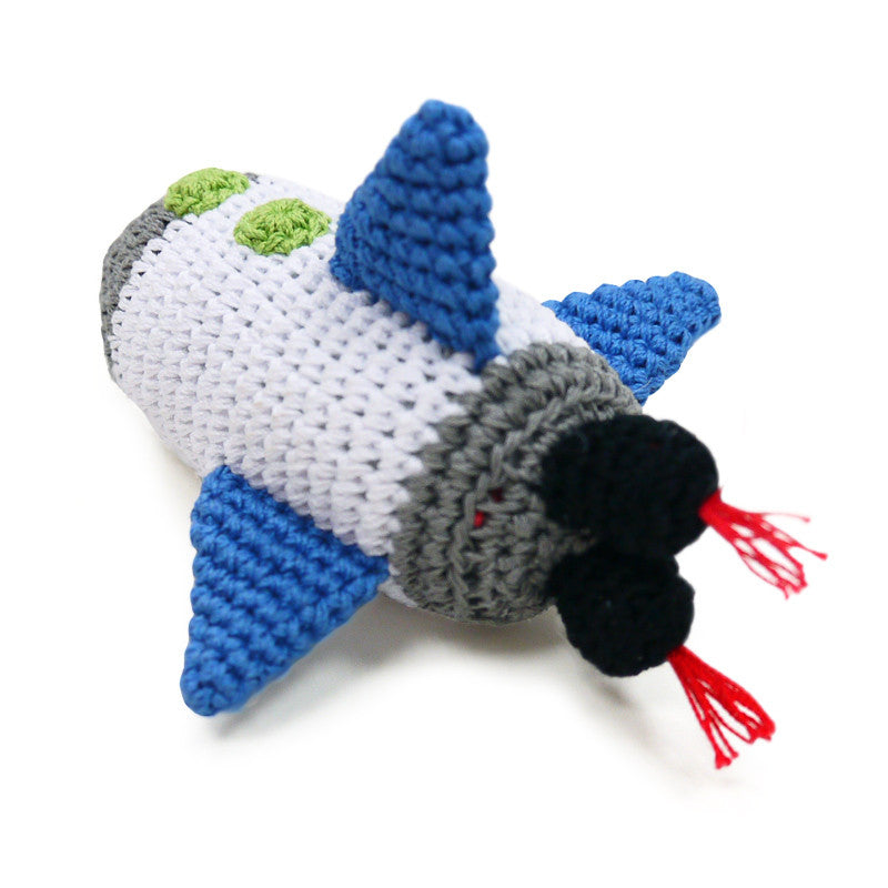 Crochet spaceship dog toy, blue and white body, gray nose, black engine, green accents, red threads