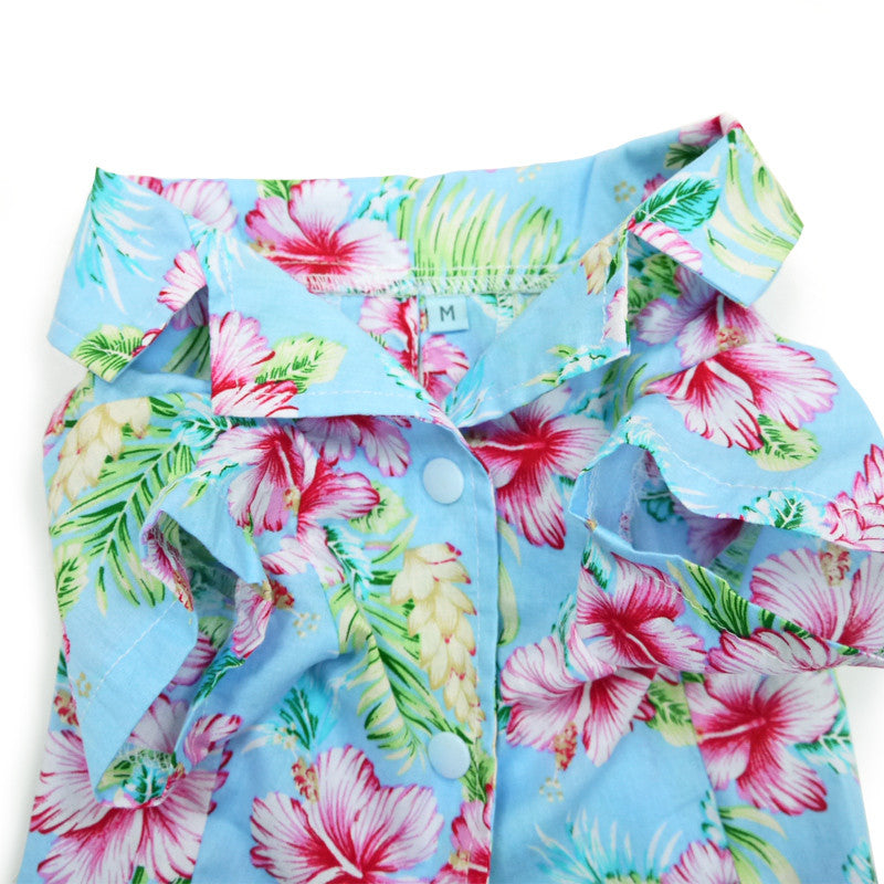 Close-up of light blue dog shirt with colorful hibiscus and leaf pattern