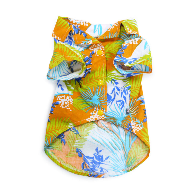 Orange tropical dog shirt, flat lay, blue and green jungle print with button-style trim