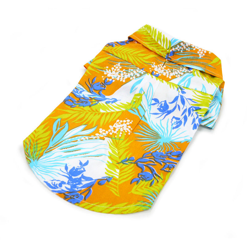 Orange tropical dog shirt, close flat view, blue and green leaf pattern with white dots