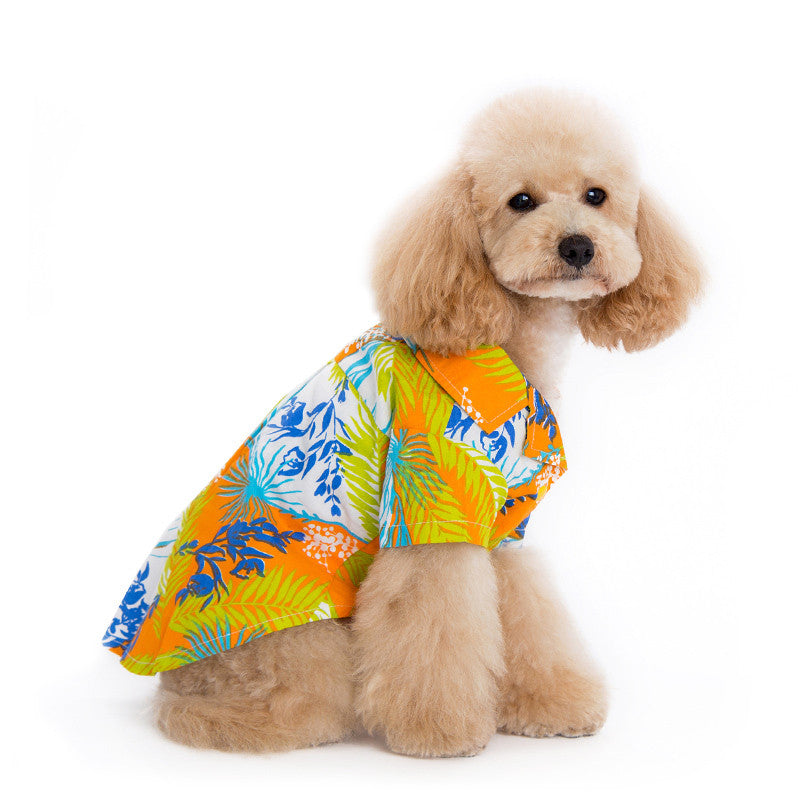 Orange tropical dog shirt with bright blue, green, and white jungle leaf pattern