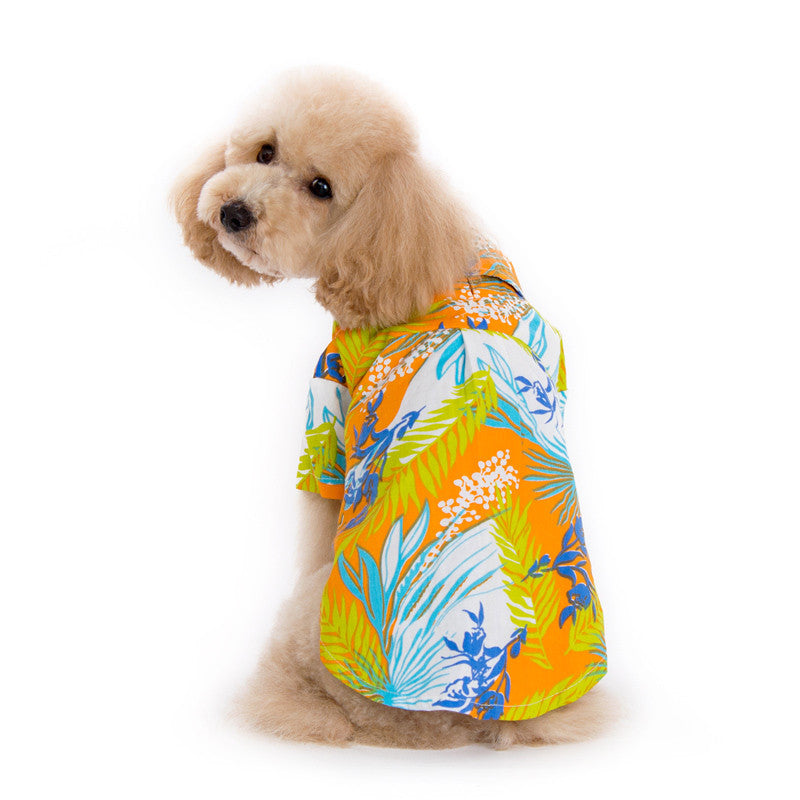 Orange tropical dog shirt, side view, blue and green jungle leaves with white accents
