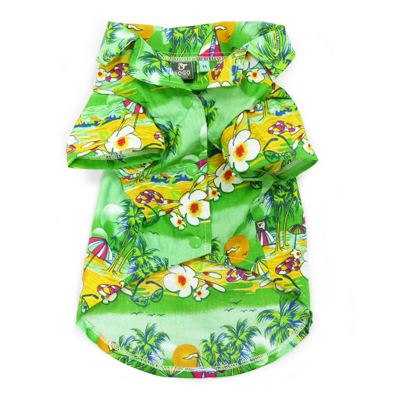 Green tropical island dog shirt with parrot, palm, umbrella, and flower print; label tag