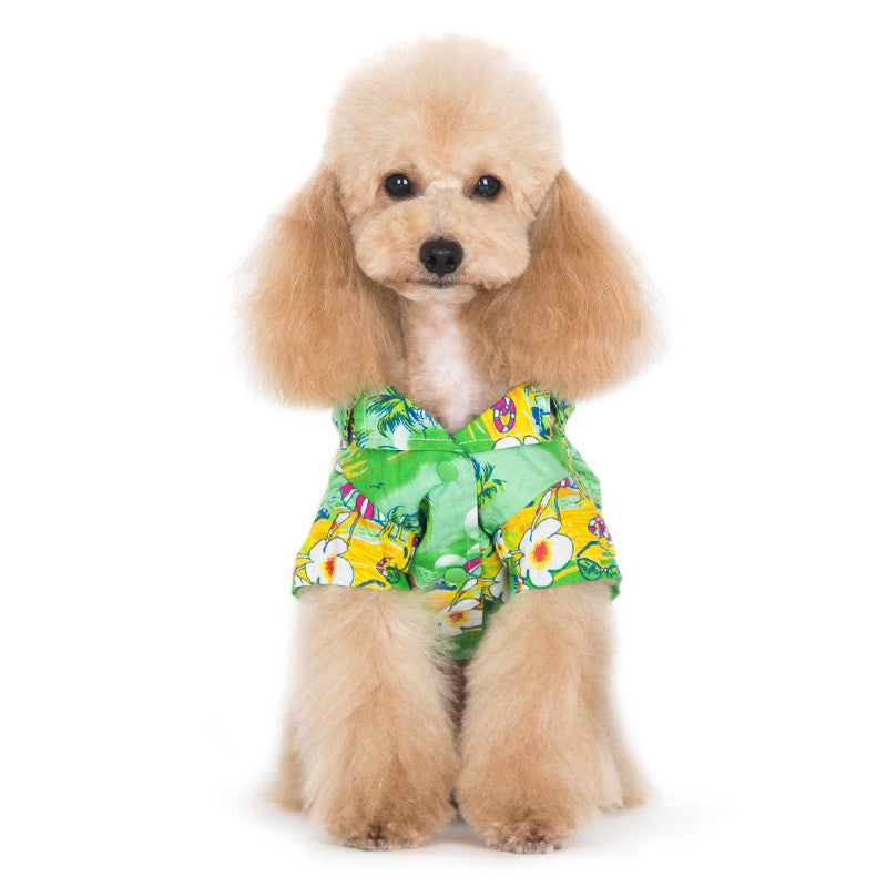 Green tropical island dog shirt with all-over parrot, palm, and flower pattern