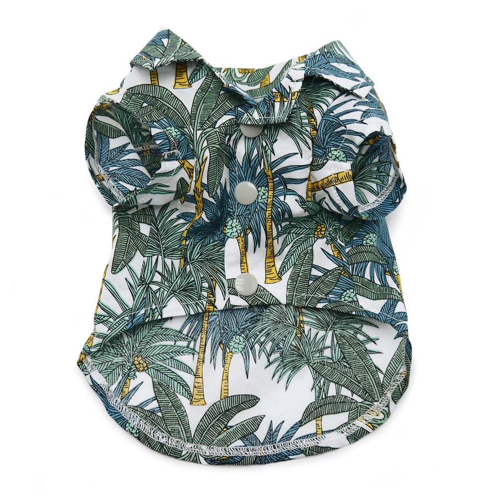 Dog shirt with tropical leaf print and snap buttons, white background with blue-green
