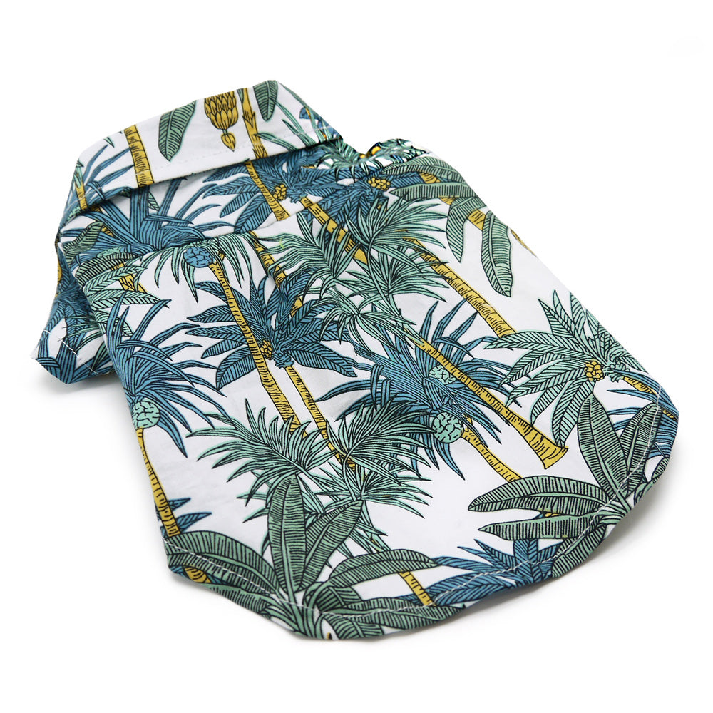 Dog polo shirt with tropical leaf print, white fabric with blue, green, yellow details