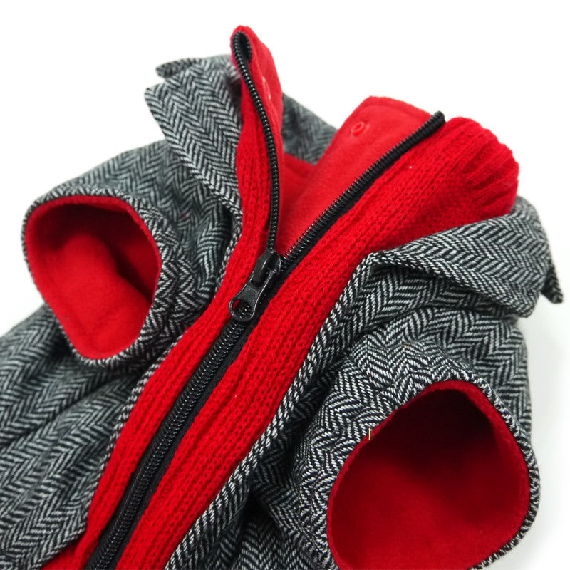 Close-up of gray tweed dog coat with red lining, black zipper, and red-lined sleeves