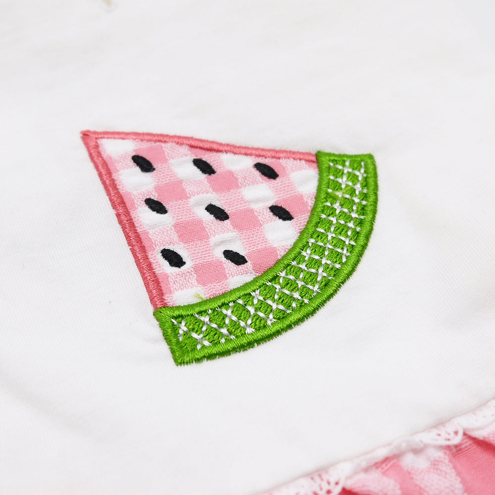 Close-up: watermelon slice applique with green stitched border on white dog dress