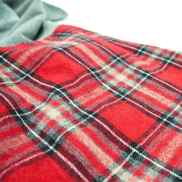 Red plaid dog costume cloth with black and gray check pattern close-up.